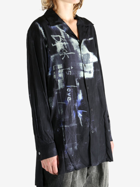 Black shirt worn by a person, showing the shirt's fit