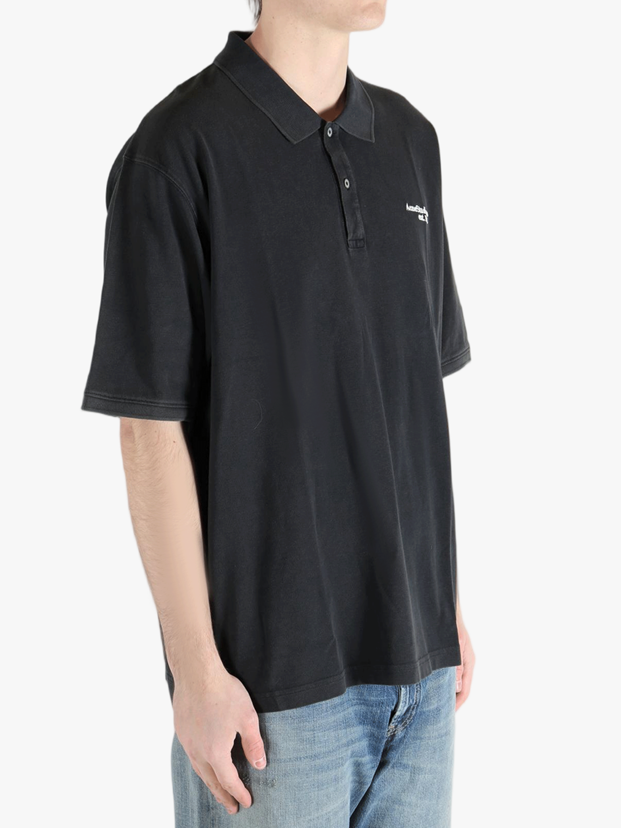 Black t-shirt worn by a person, showing the cotton fit