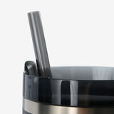 Close up of black tumbler, showing texture of the stainless steel fabric
