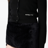 Close up of black knitwer, showing texture of the wool fabric