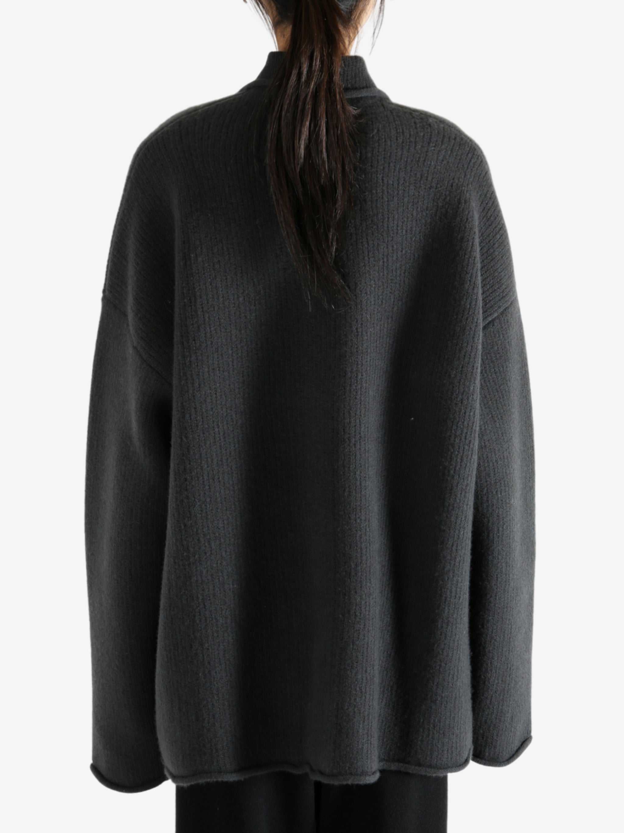 Grey jacket worn by a person, showing the jacket's fit