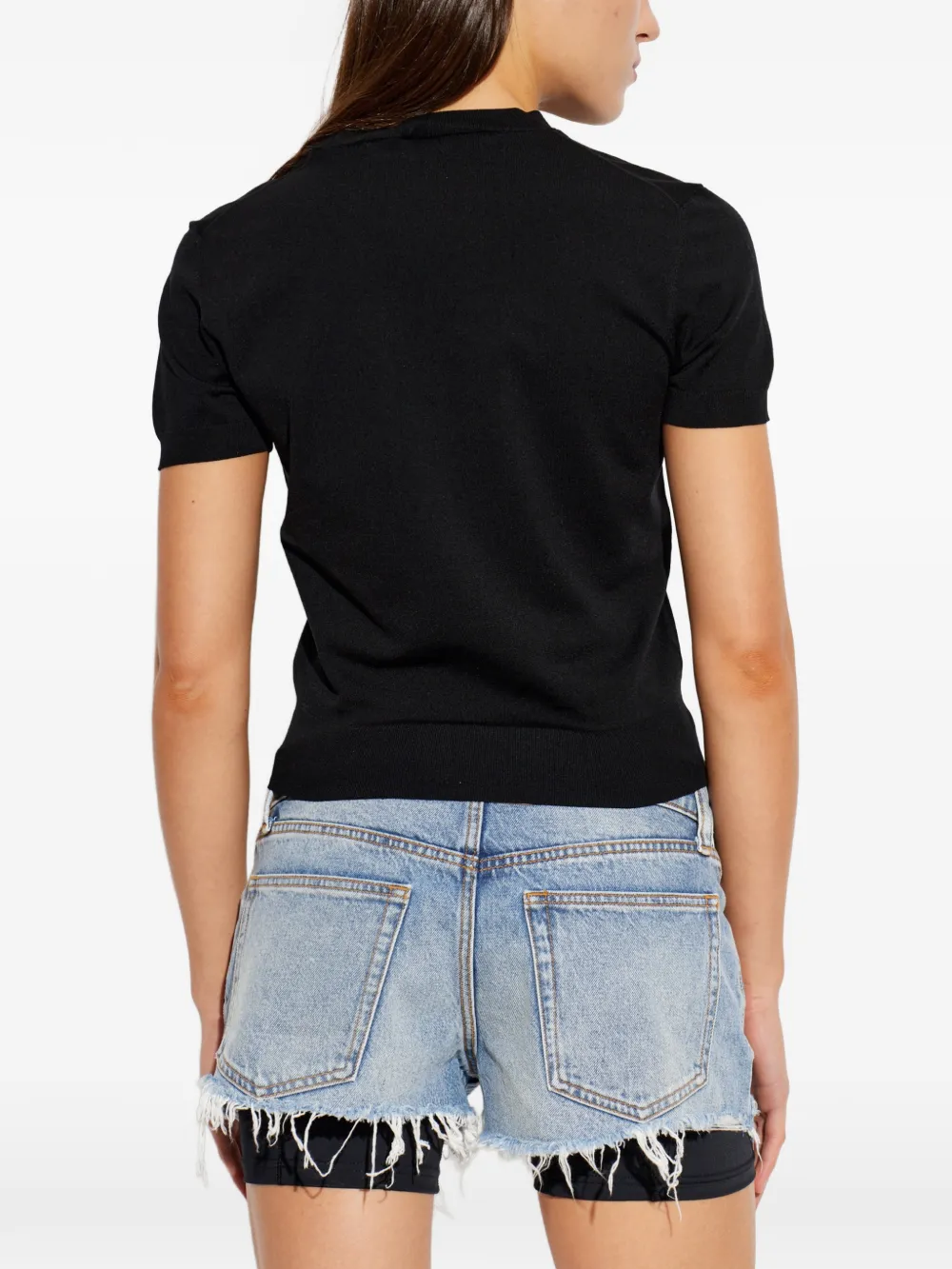Black t-shirt worn by a person, showing the t-shirt fit
