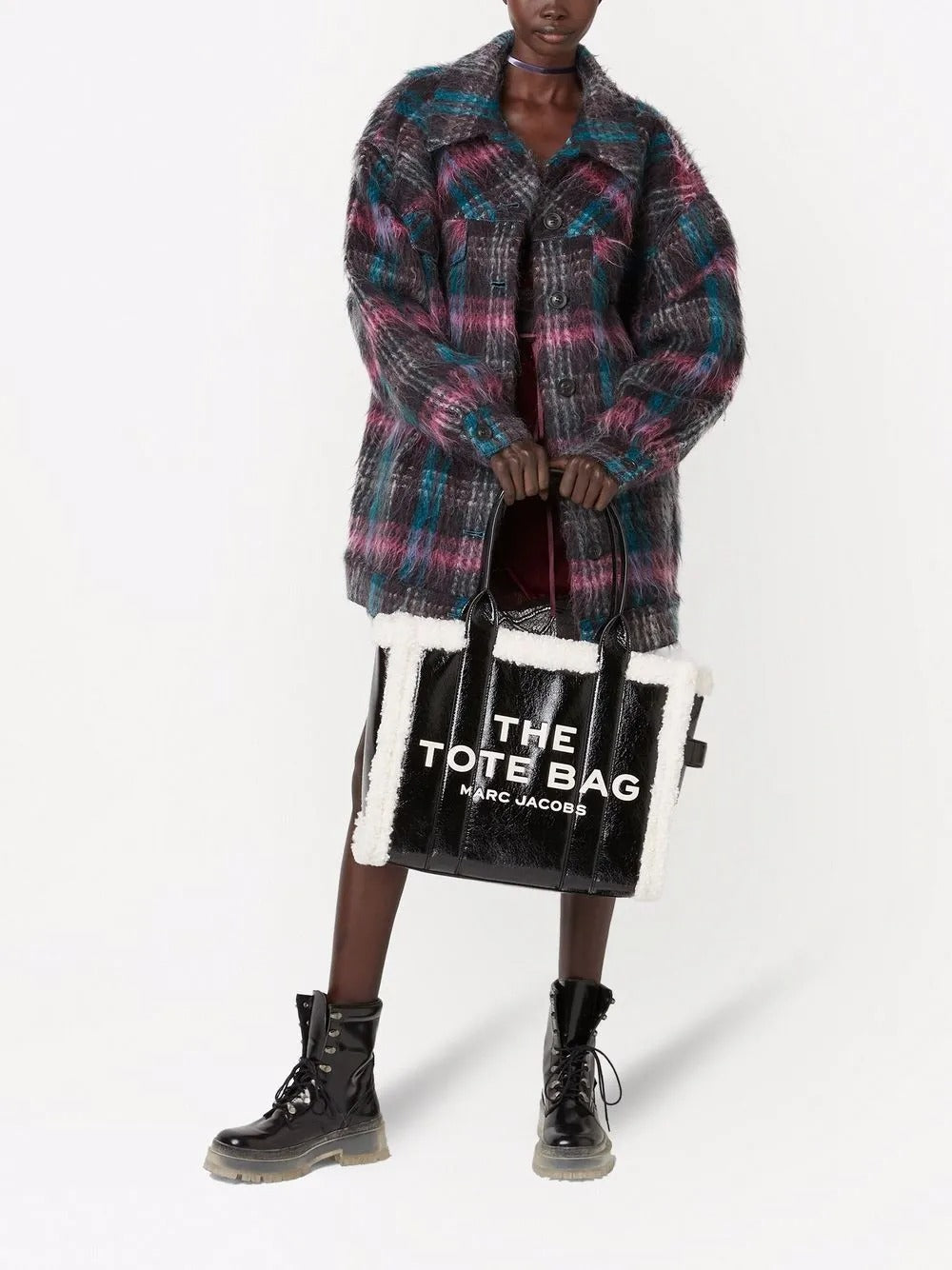 Black bag carried by a person, showing the bag's fit