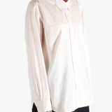 Tan shirts worn by a person, showing the shirt's fit