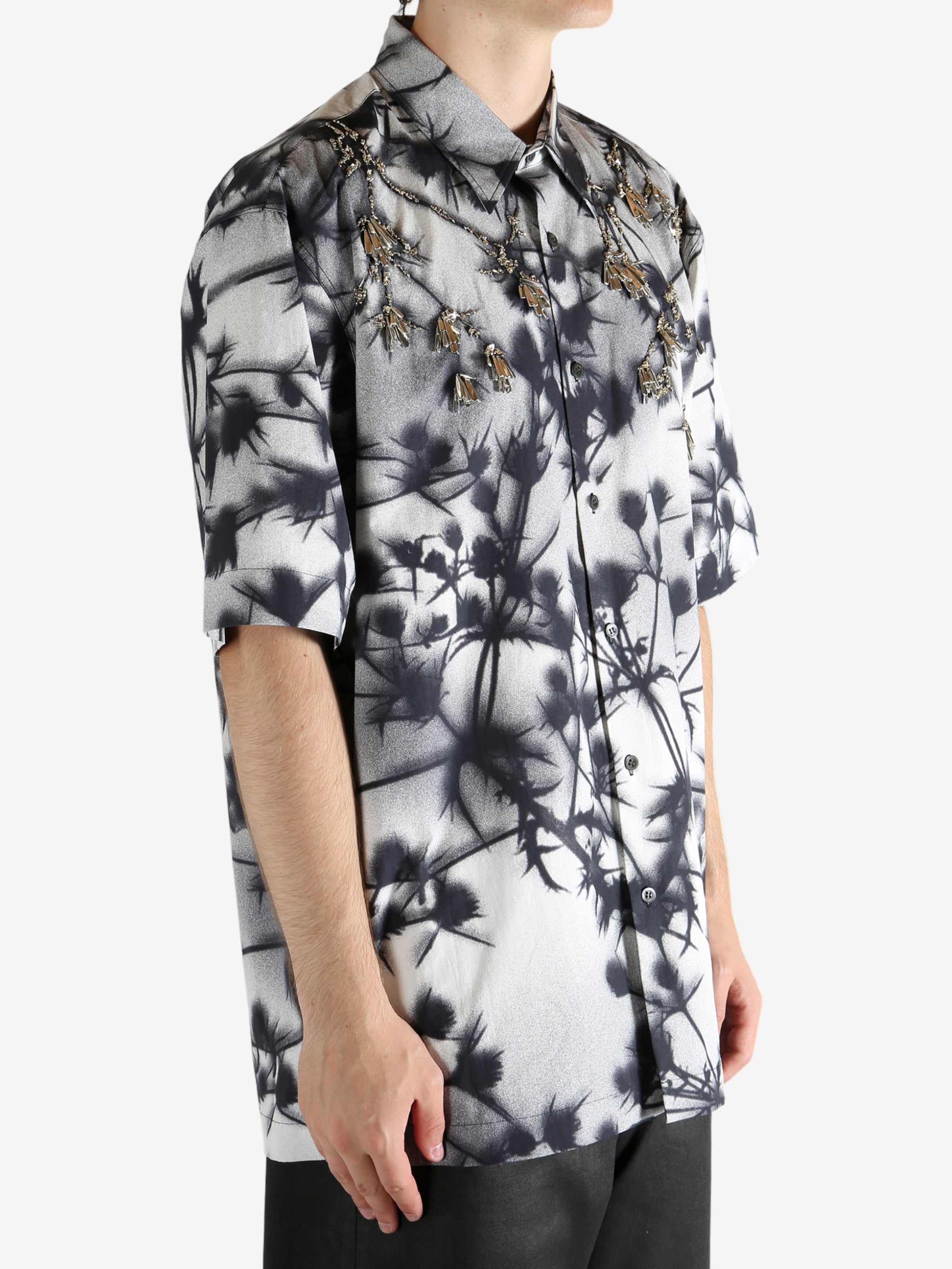 Black shirt worn by a person, showing the shirt's fit