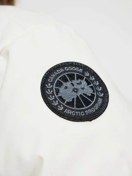 Close up of white jacket,showing texture of the recycled polyester fabric.