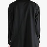 Black shirt worn by a person, showing the shirt's fit
