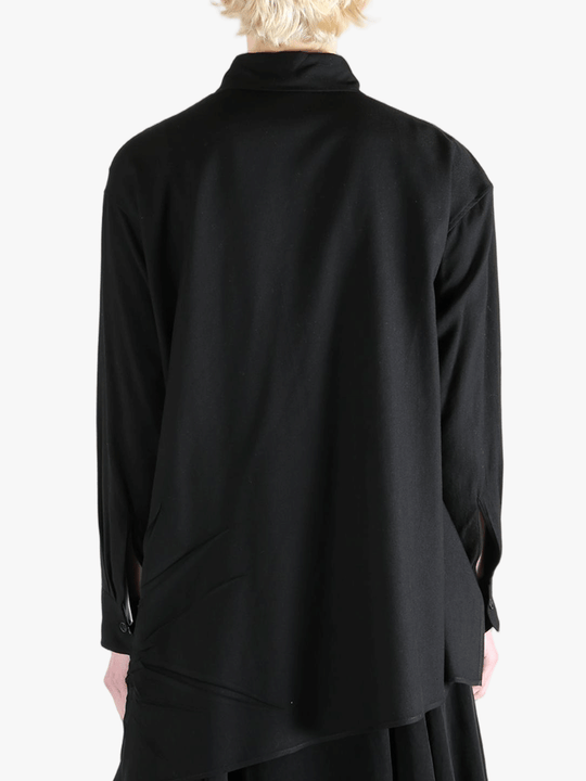 Black shirt worn by a person, showing the shirt's fit