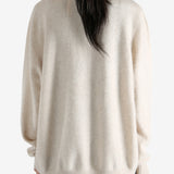 Tan cardigan worn by a person, showing the cardigan's fit