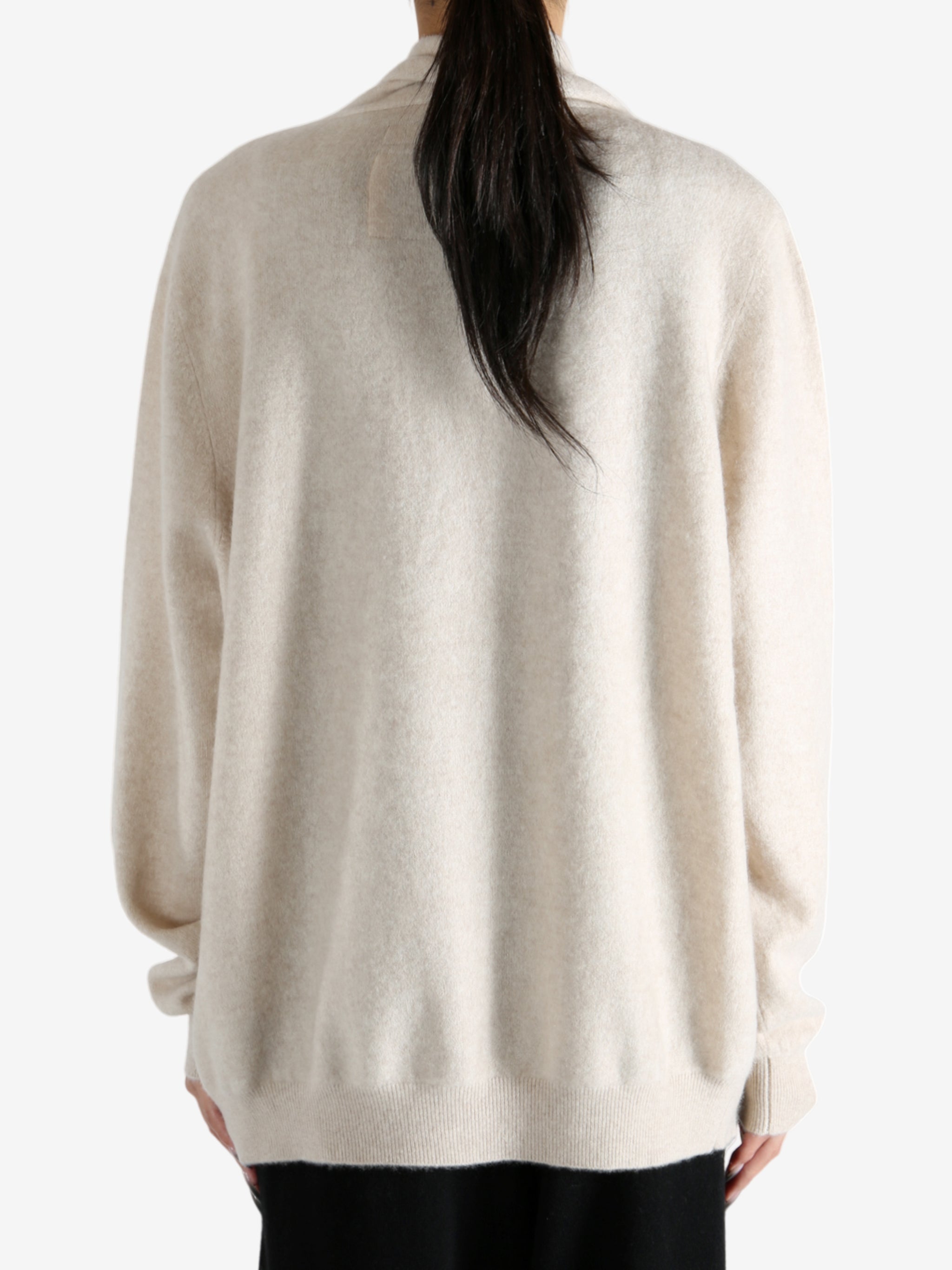 Tan cardigan worn by a person, showing the cardigan's fit