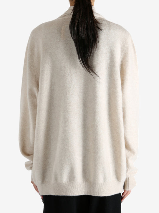 Tan cardigan worn by a person, showing the cardigan's fit