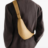 Tan bag worn by a person, showing the bag fit