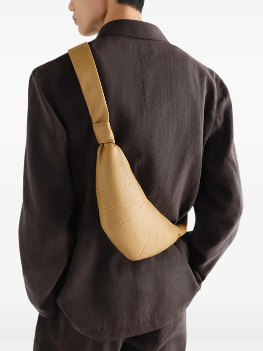 Tan bag worn by a person, showing the bag fit