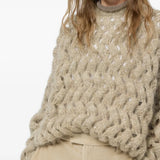 Tan knitwear worn by a person, showing the knitwear fit