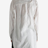 White shirt worn by a person, showing the shirt's fit