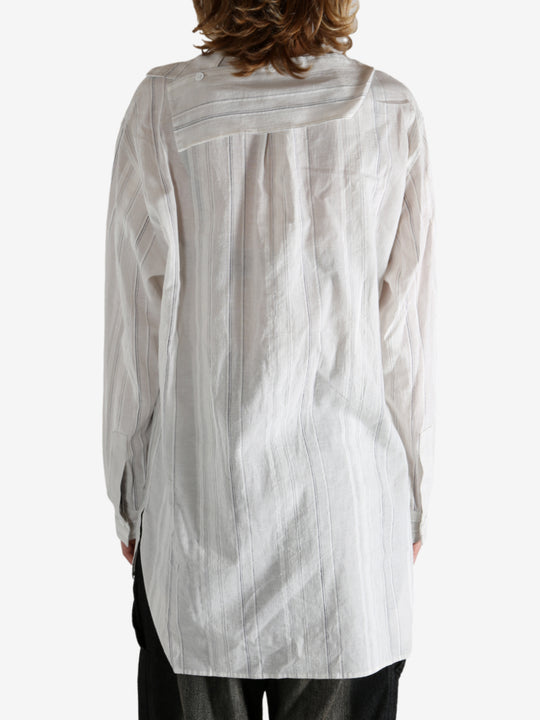 White shirt worn by a person, showing the shirt's fit