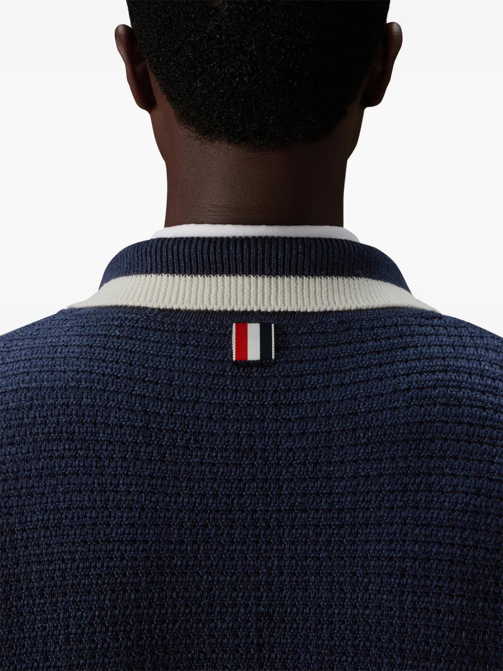 Navy knitwear worn by a person, showing the knitwear fit