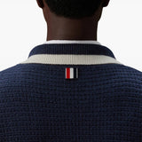 Navy knitwear worn by a person, showing the knitwear fit