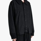 Black jacket worn by a person, showing the jacket fit