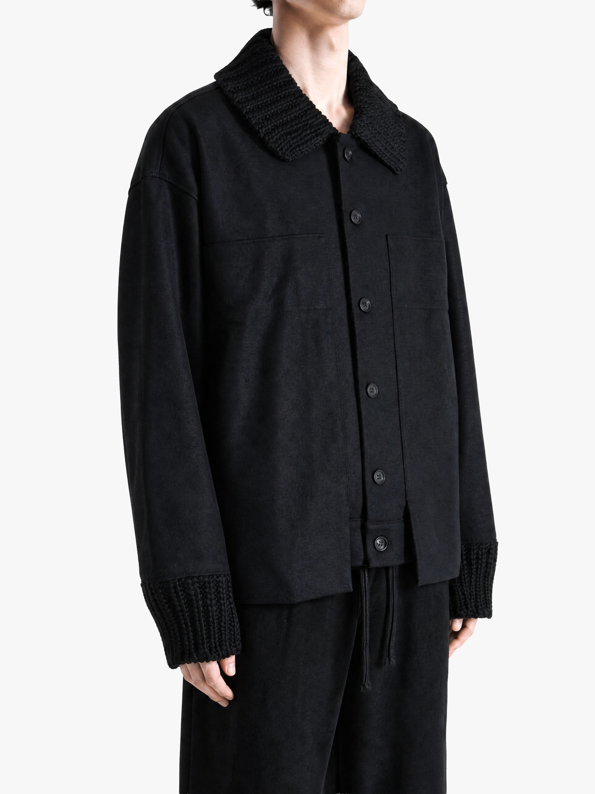 Black jacket worn by a person, showing the jacket fit