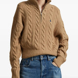 Brown knitwear worn by a person, showing the knitwear's fit