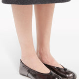Black flats worn by a person, showing the flats fit