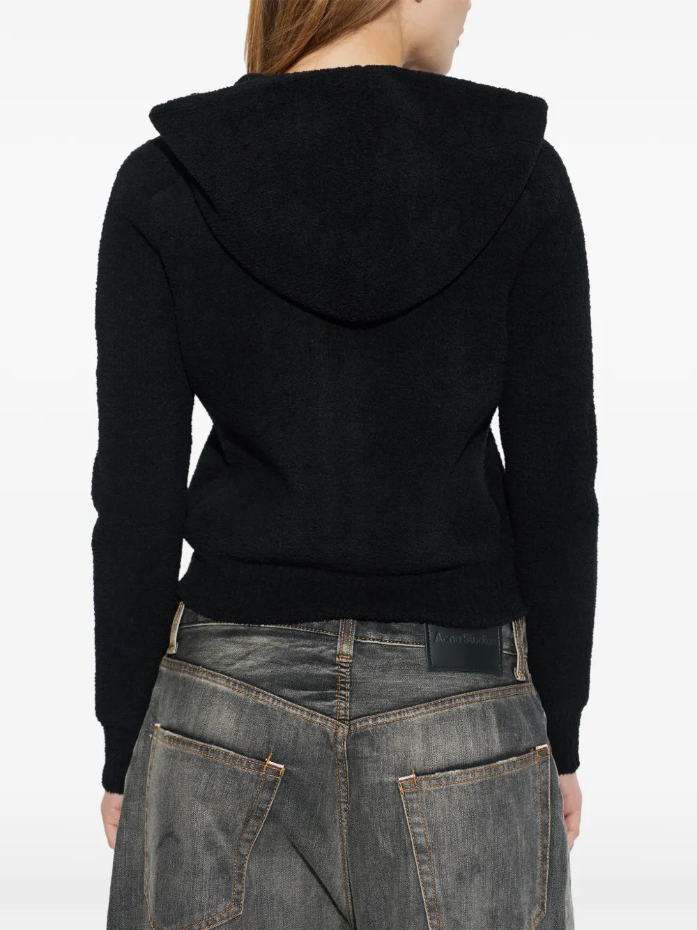 black hoodie worn by a person, showing the bag fit