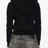 black hoodie worn by a person, showing the hoodie fit