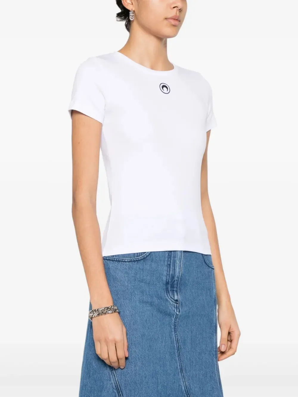 White t-shirt worn by a person, showing the t-shirt's fit