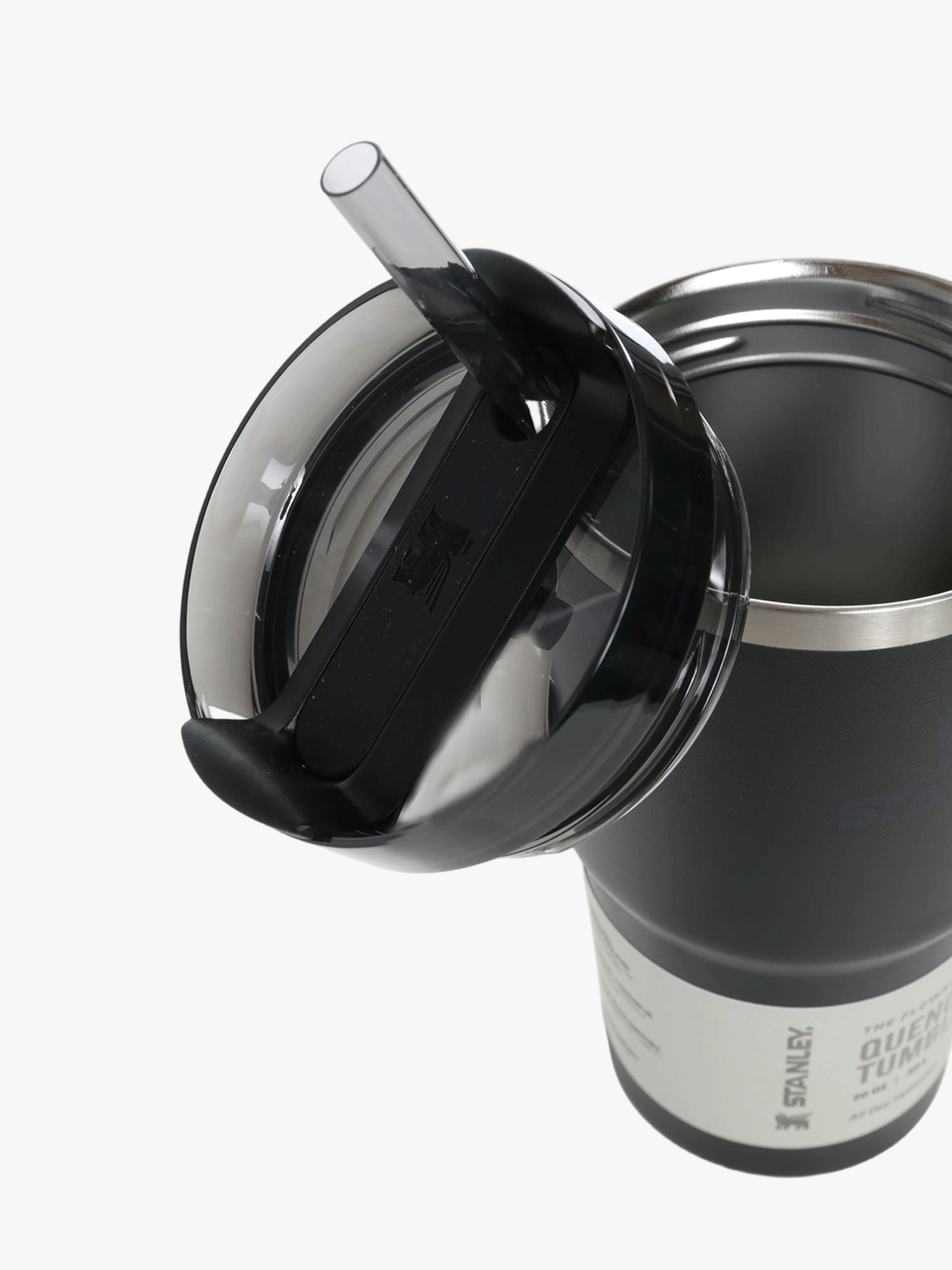 Close up of black tumbler, showing texture of the stainless steel fabric