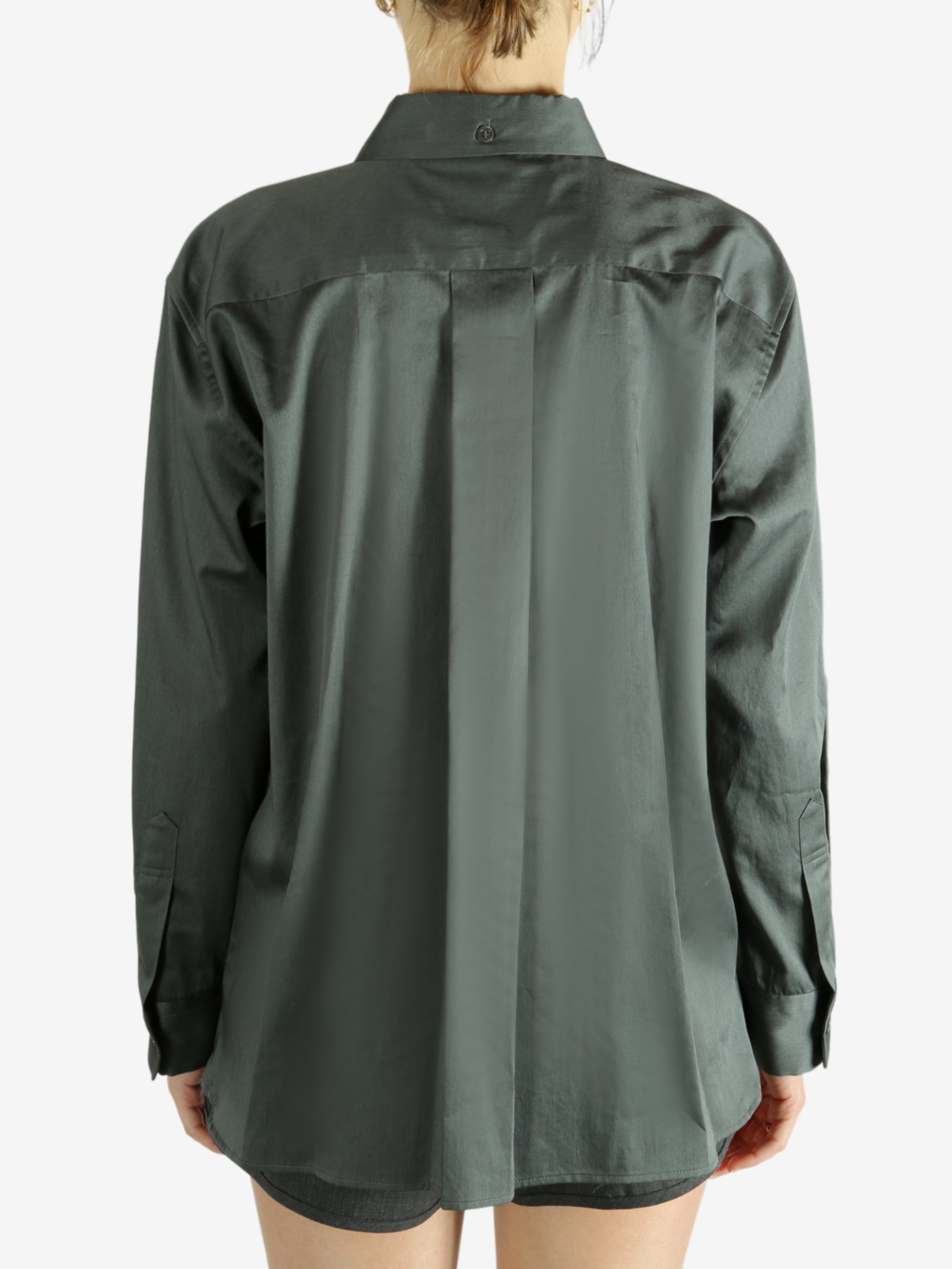 Green shirt worn by a person, showing the shirt's fit