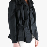 Black jacket worn by a person, showing the jacket's fit