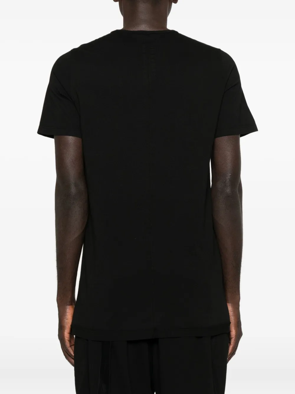 Black t-shirt worn by a person, showing the shirt's fit