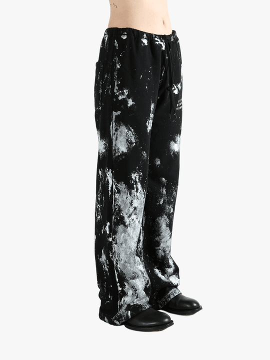 Black pants worn by a person, showing the pants' fit
