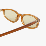 Close up of the yellow sunglasses, showing texture of the acetate fabric