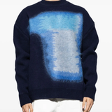 Blue sweater worn by a person, showing the sweater's fit