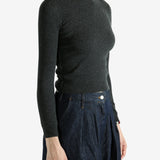 Grey sweater worn by a person, showing the sweater's fit