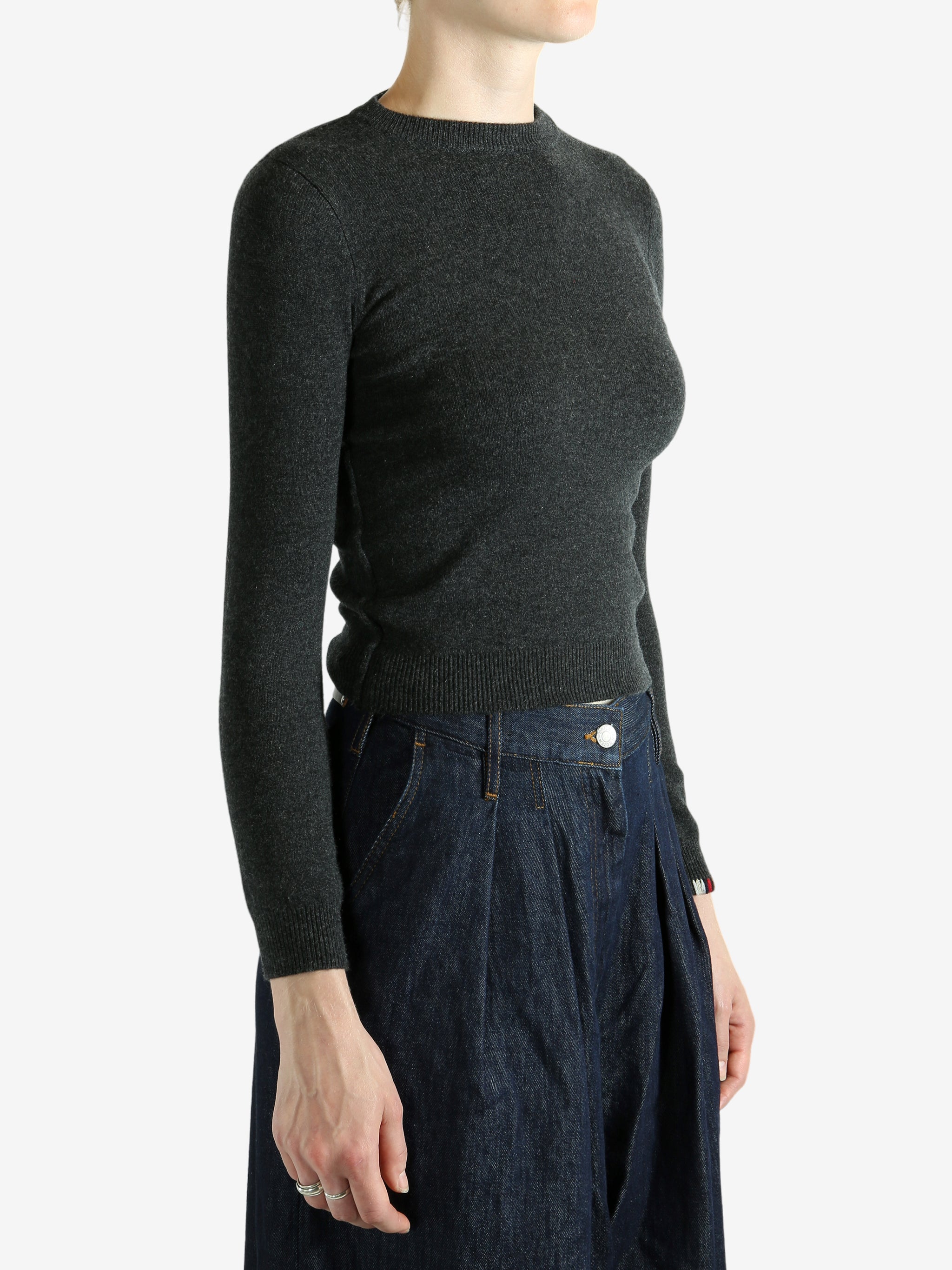 Grey sweater worn by a person, showing the sweater's fit