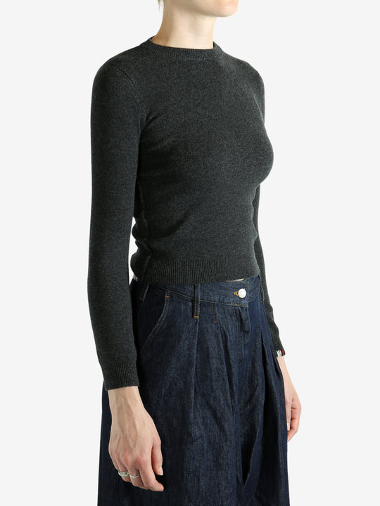 Grey sweater worn by a person, showing the sweater's fit