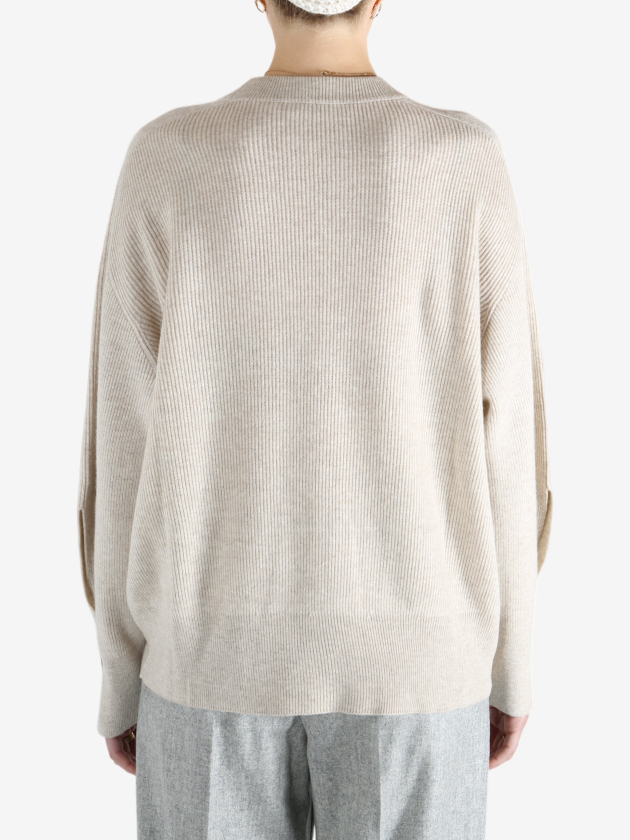 Grey knitwear worn by a person, showing the knitwear fit