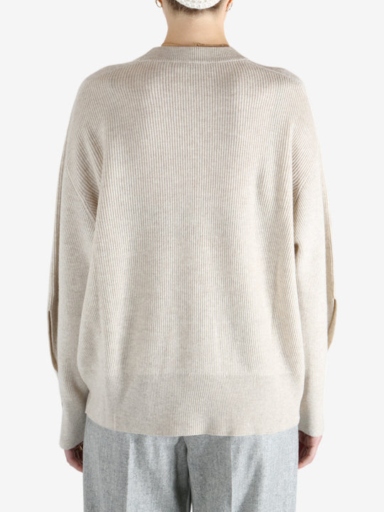 Grey knitwear worn by a person, showing the knitwear fit