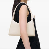 White bag worn by a person, showing the bag's fit