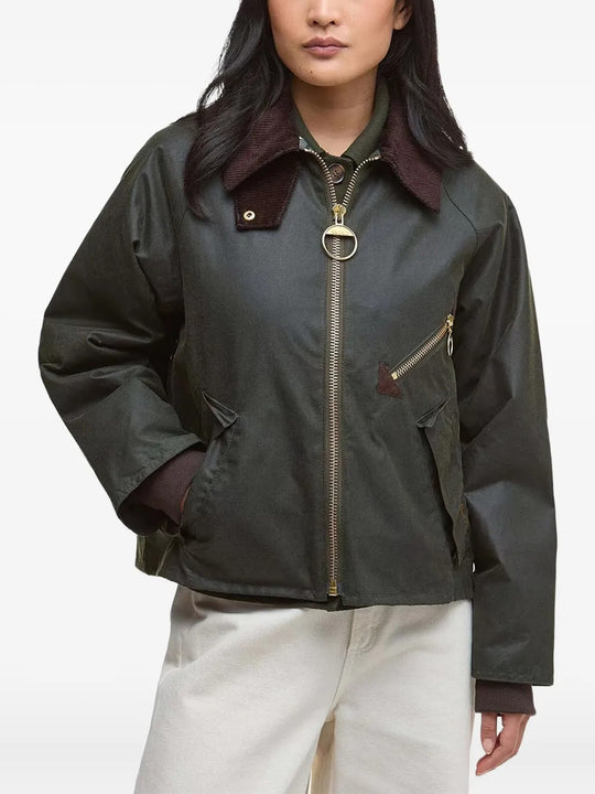 Green jacket worn by a person, showing the jacket fit