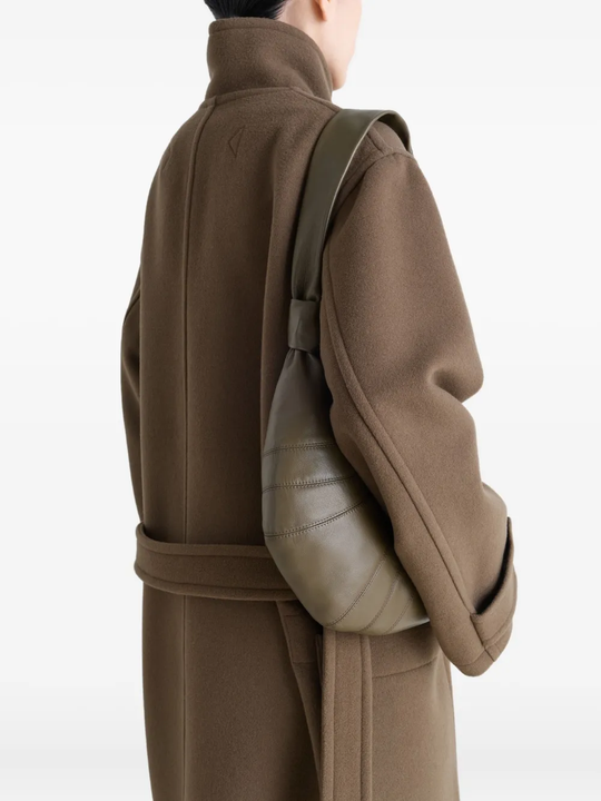 Green bag worn by a person, showing the bag's fit