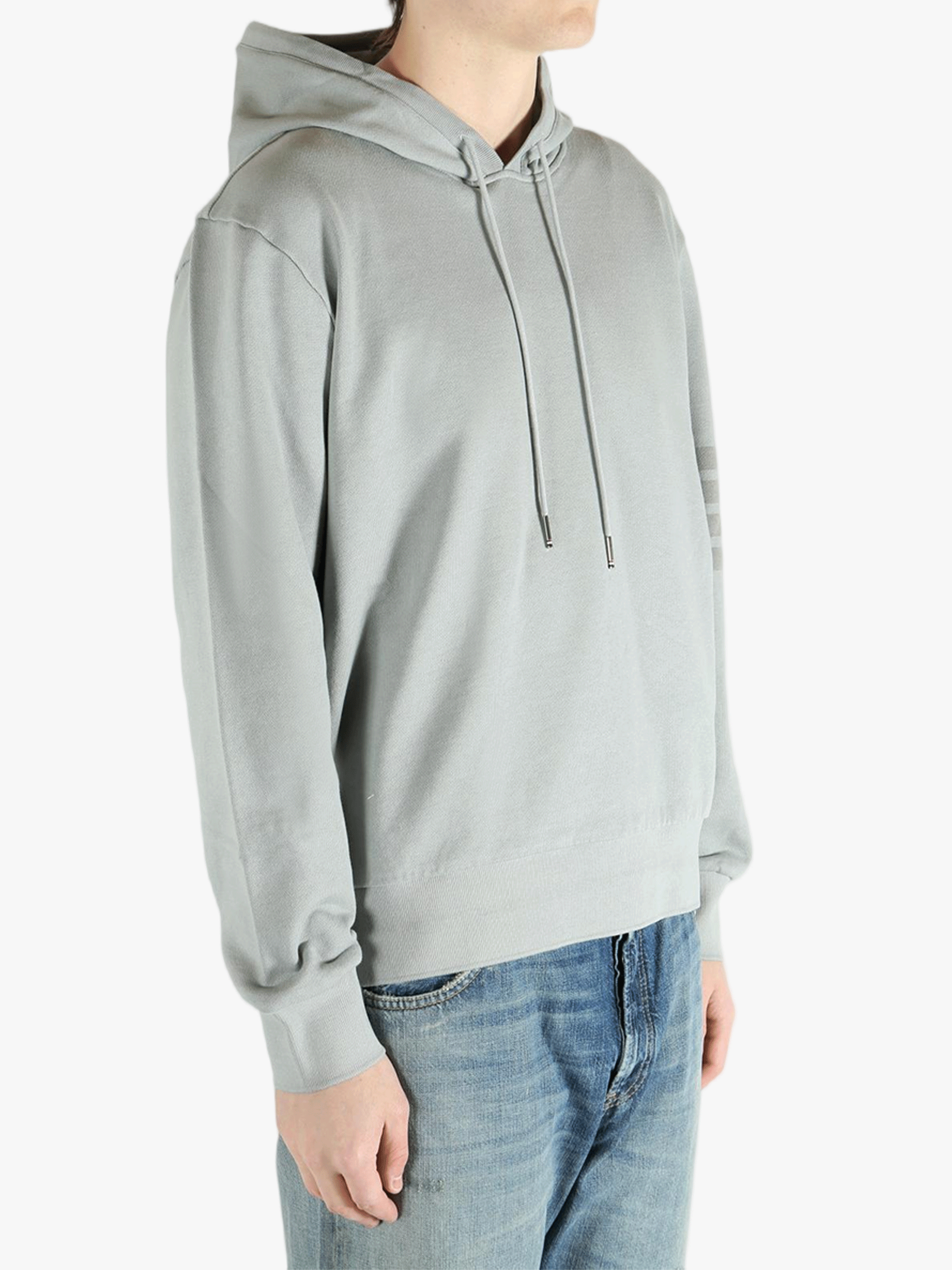 Grey hoodie worn by a person, showing the hoodie fit