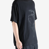 Black t-shirts worn by a person, showing the t-shirts' fit