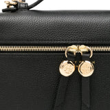 Close up of black bag, showing texture of the leather fabric