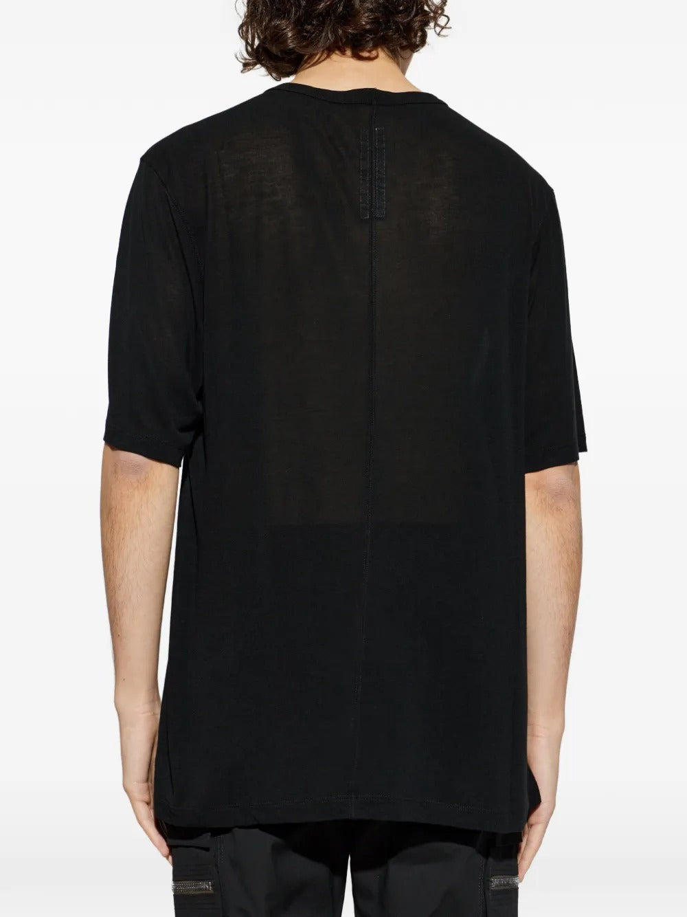 Black t-shirts worn by a person, showing the t-shirts fit