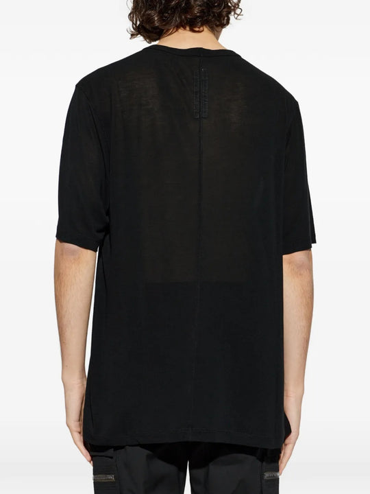 Black t-shirts worn by a person, showing the t-shirts fit