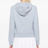 blue hoodie worn by a person, showing the hoodie fit